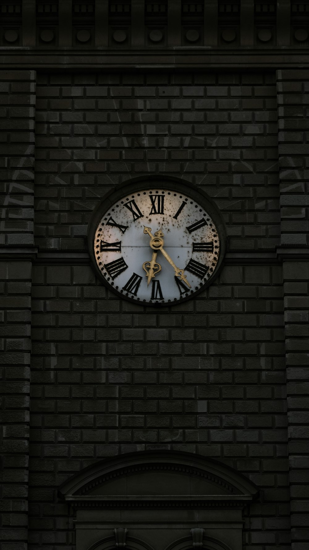 a large clock on the side of a brick building