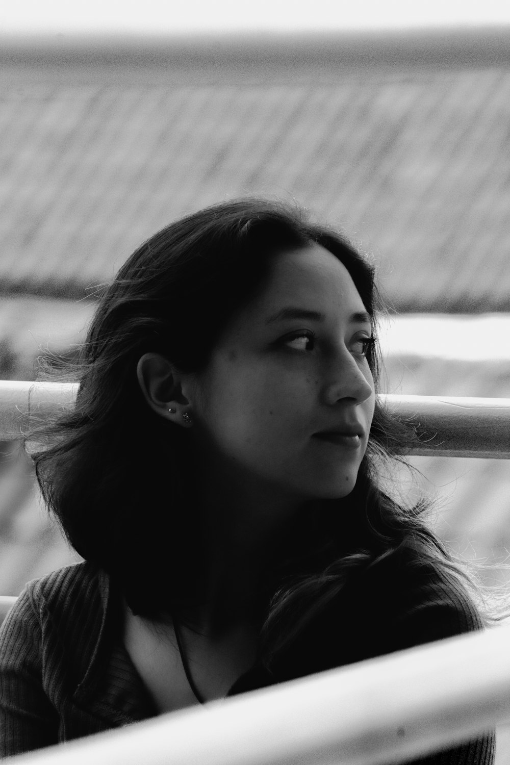 a black and white photo of a woman looking off into the distance