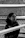 a woman sitting on a balcony with a cell phone in her hand