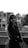 a black and white photo of a woman standing on a balcony