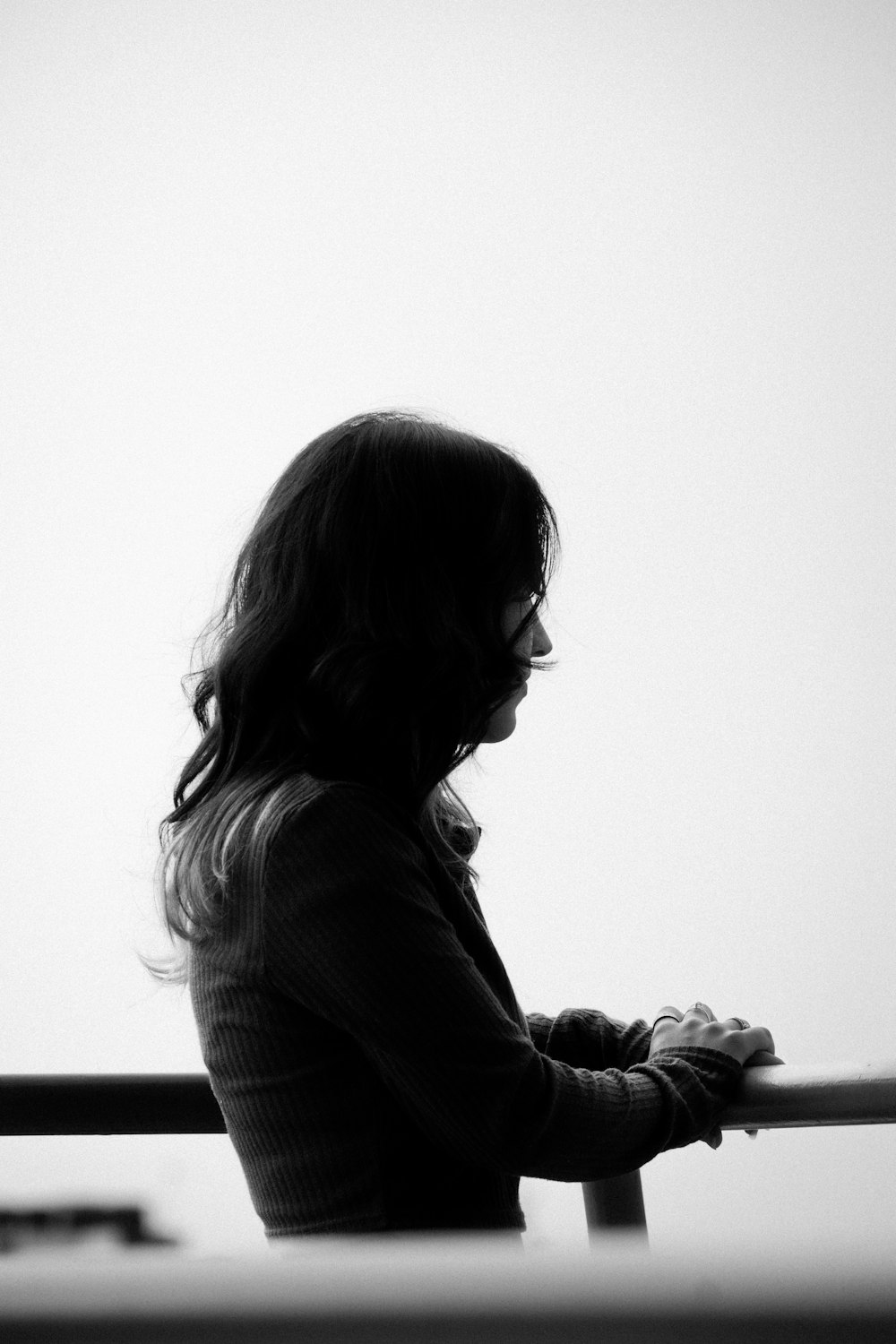 a woman sitting on a bench looking at her cell phone