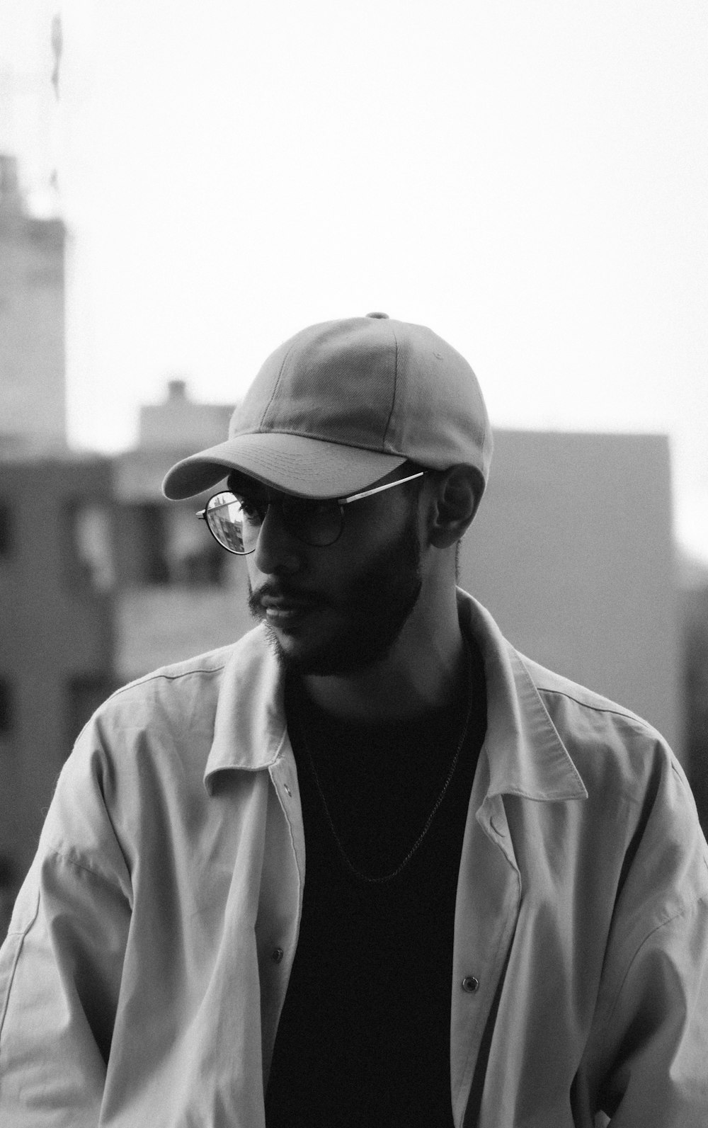 a man wearing a baseball cap and sunglasses