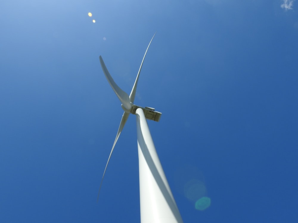 a wind turbine is shown against a blue sky