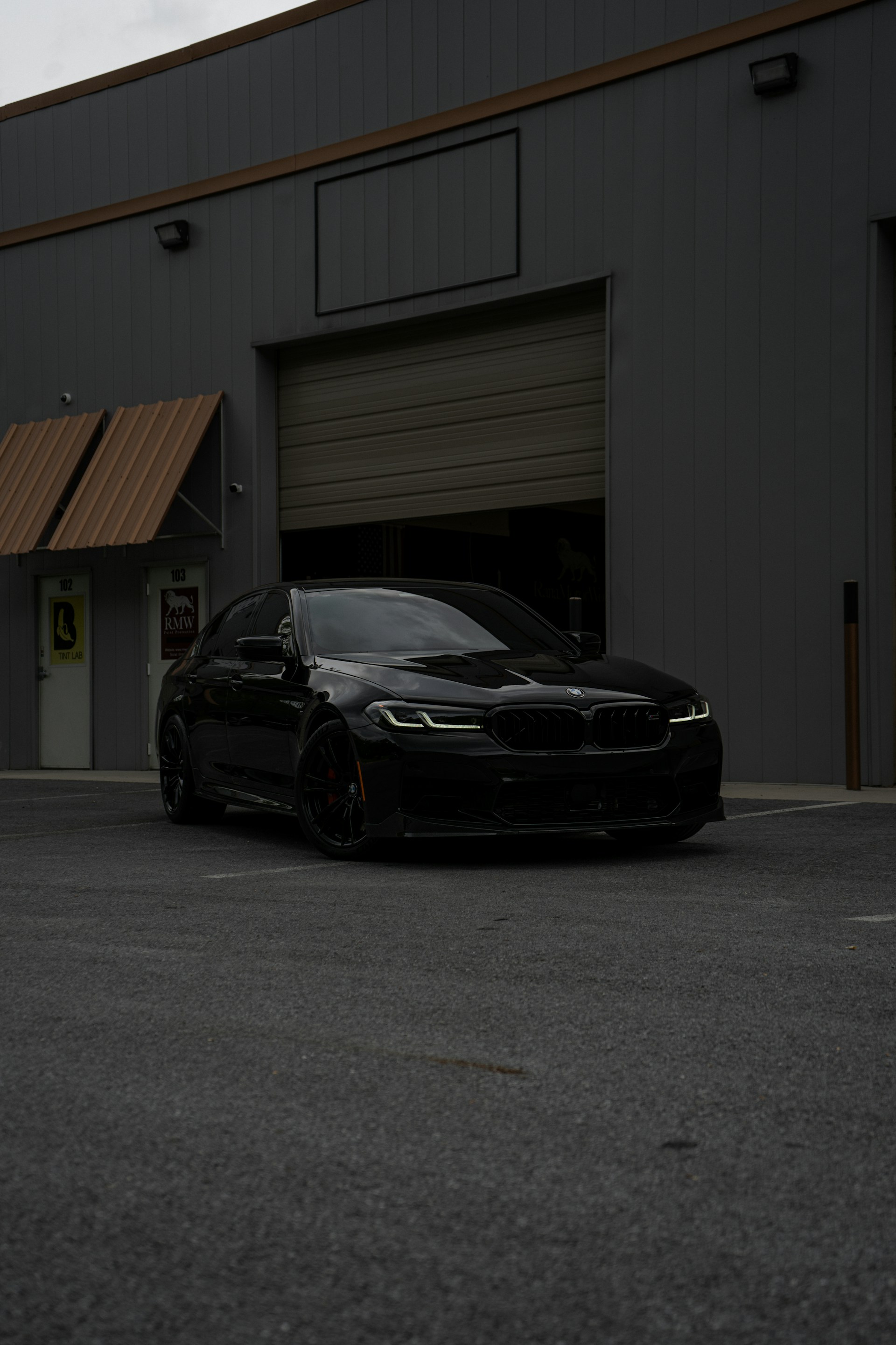 a black car parked in front of a building
