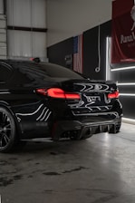 a black car parked inside of a garage