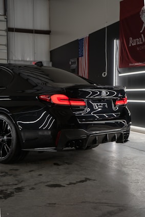 a black car parked inside of a garage