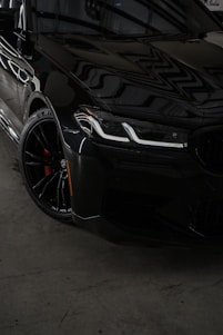 a black car parked inside of a garage