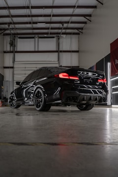 a black sports car parked in a garage