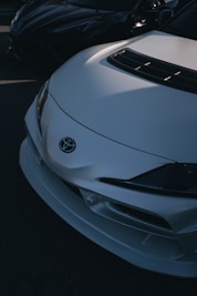 a white sports car parked in a parking lot
