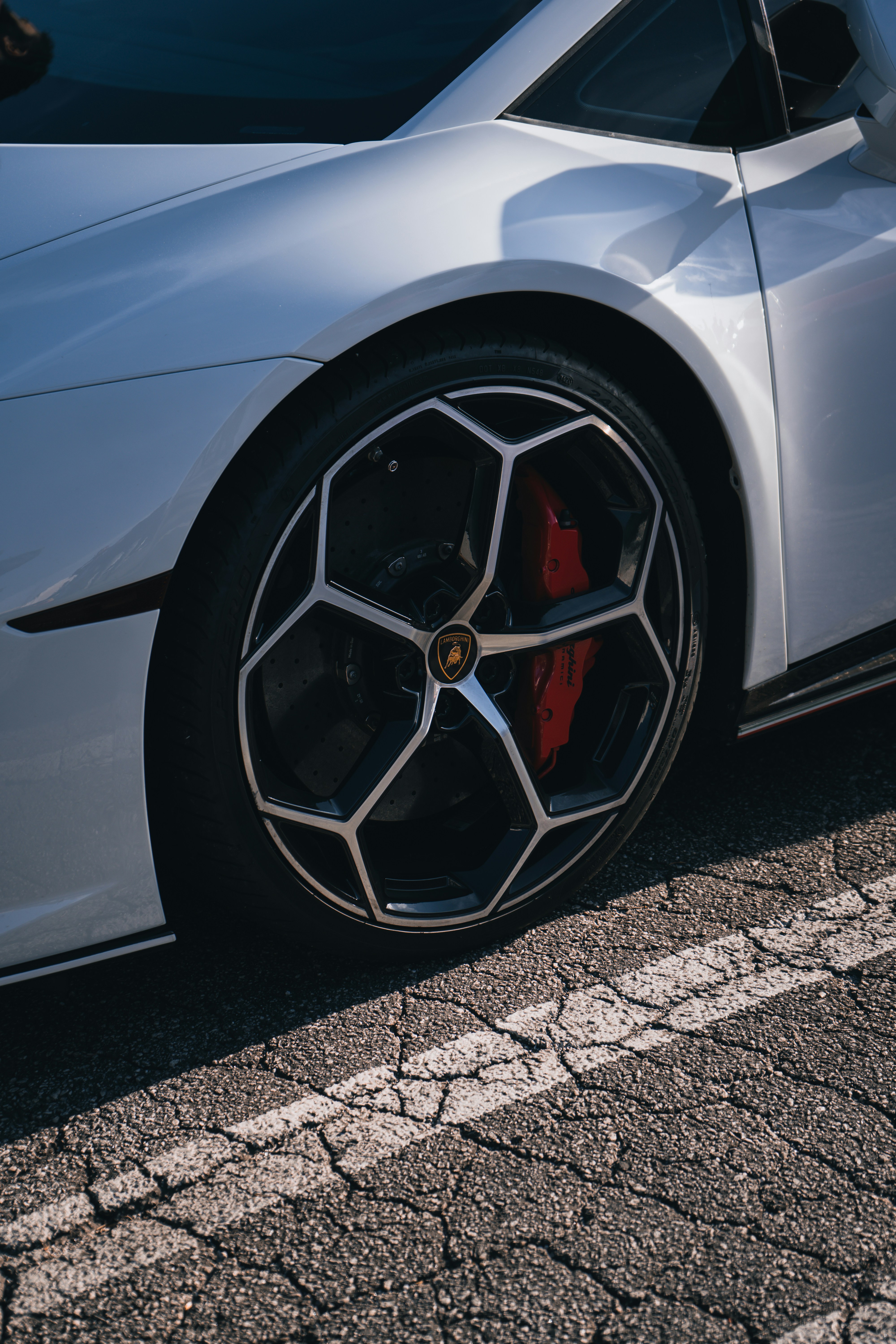 a silver sports car parked on the side of the road
