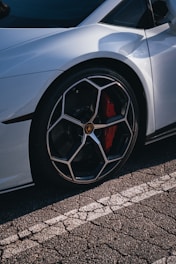 a silver sports car parked on the side of the road