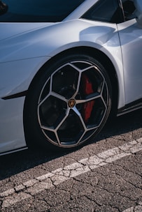 a silver sports car parked on the side of the road