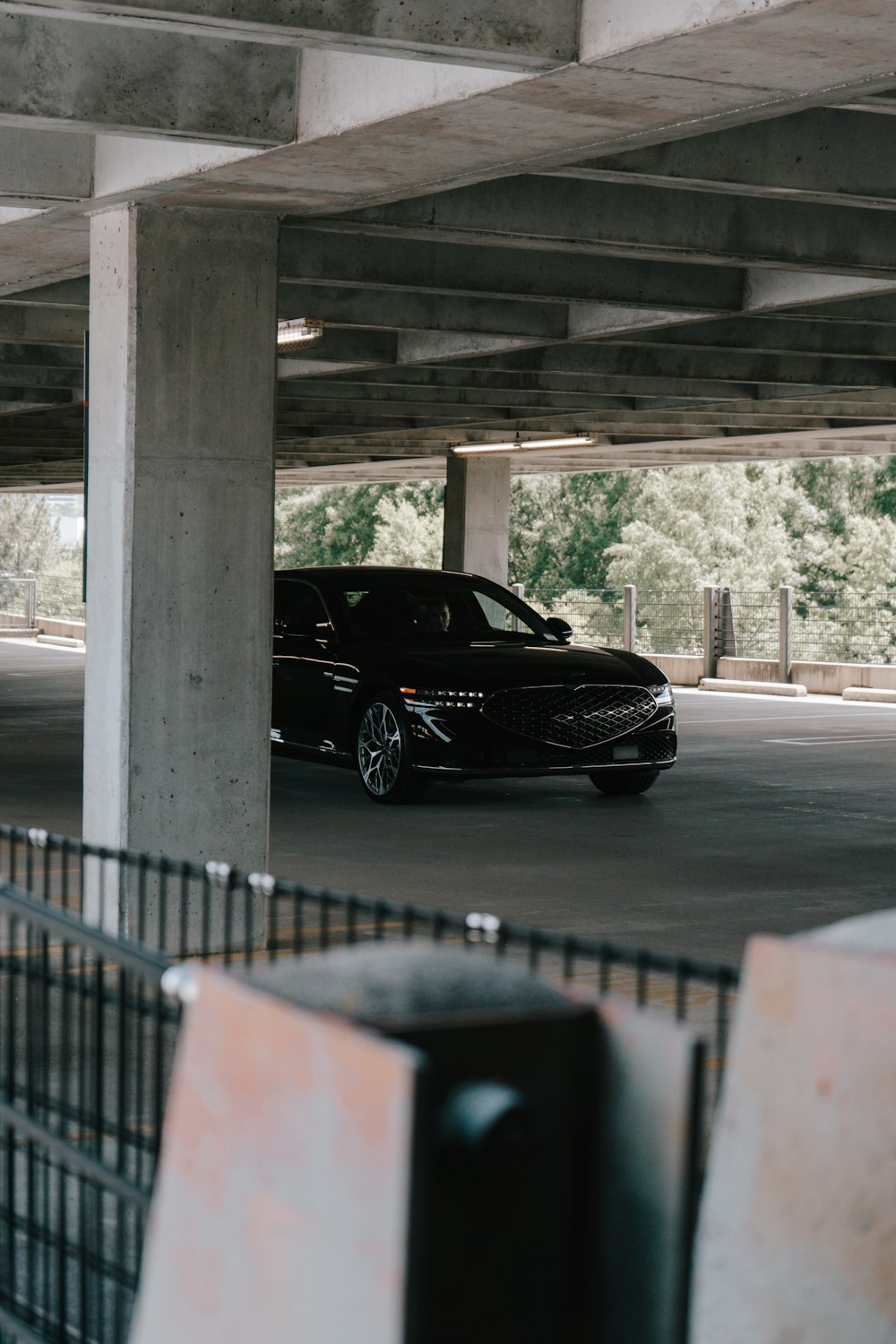 a black car parked in a parking garage