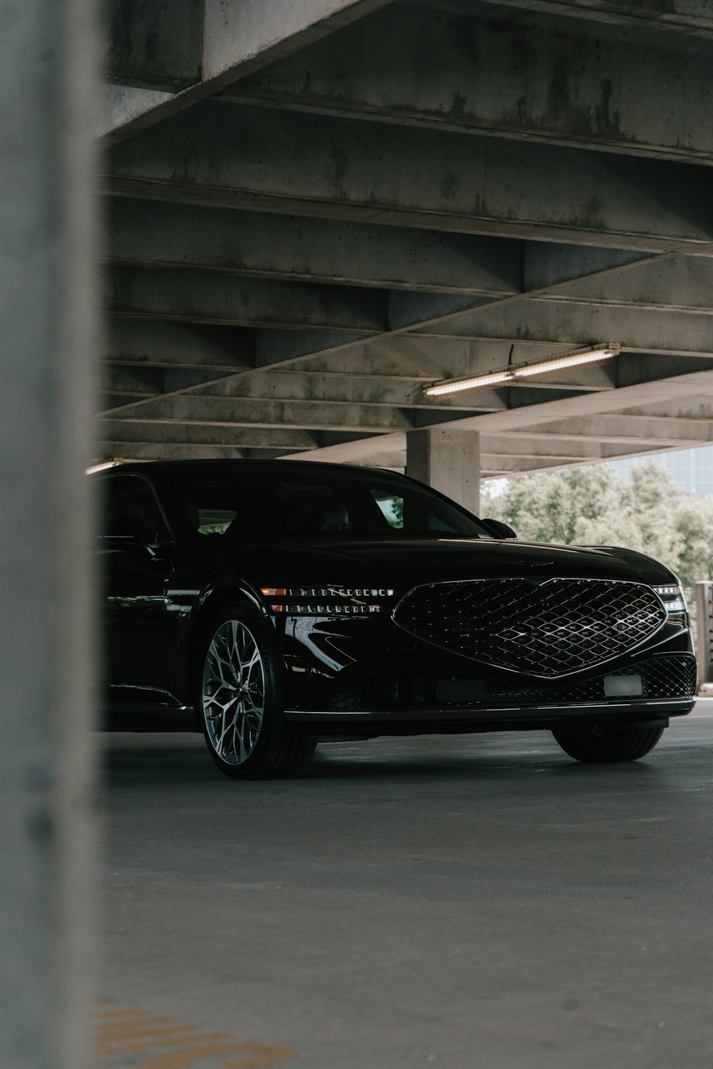 a black car parked in a parking garage