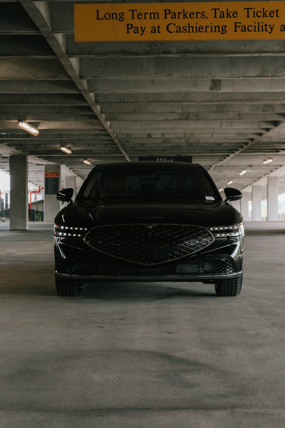 a black car parked in a parking garage