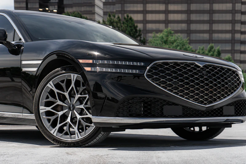 Black car with a deep, glossy ceramic coating finish parked at night