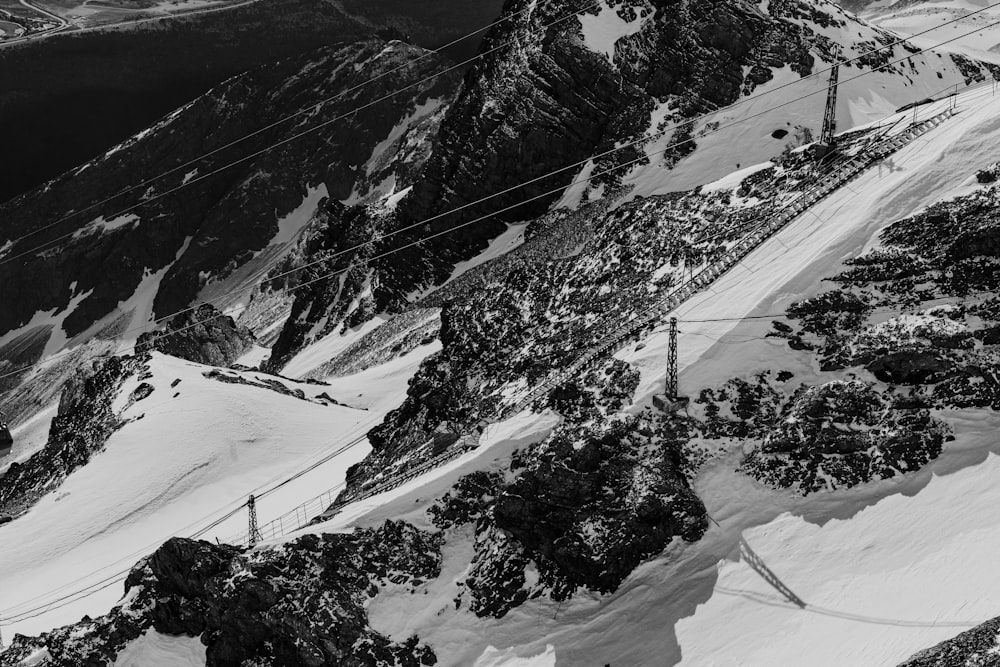 a black and white photo of a snow covered mountain