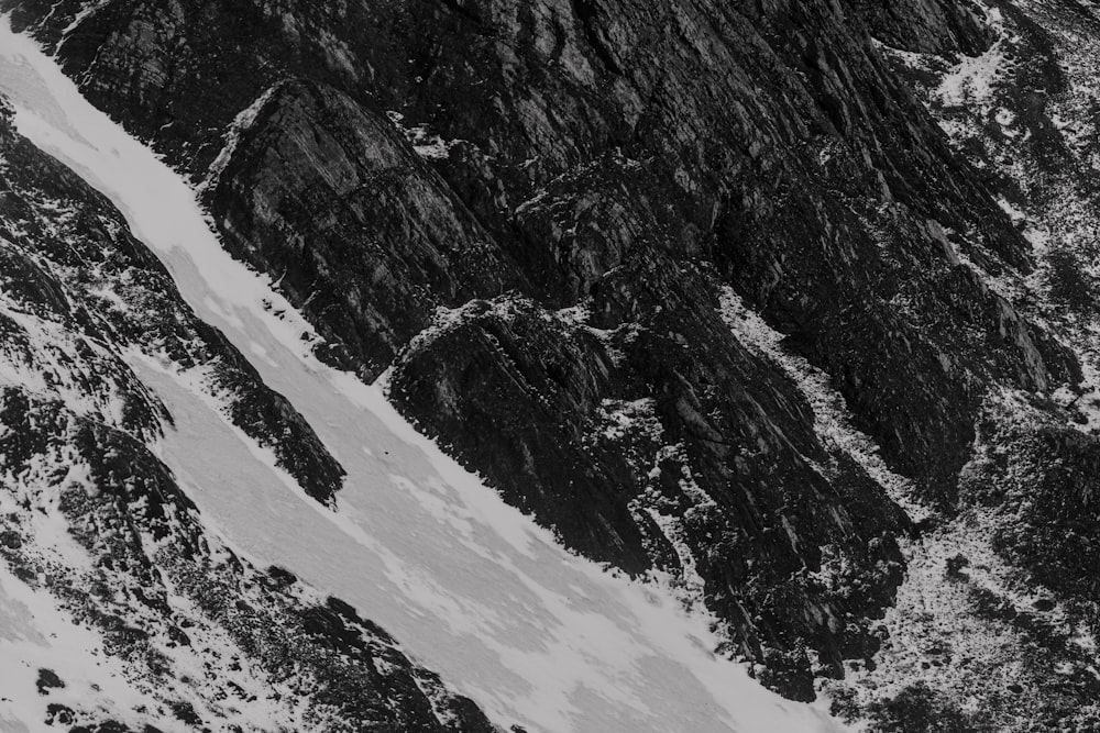 a black and white photo of a snow covered mountain