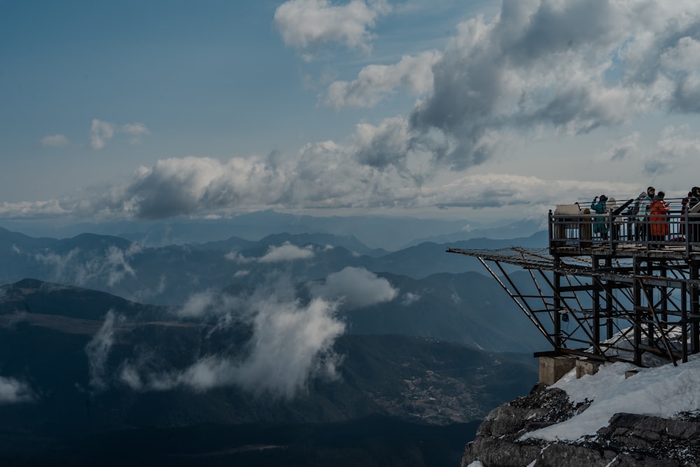 a group of people standing on top of a mountain