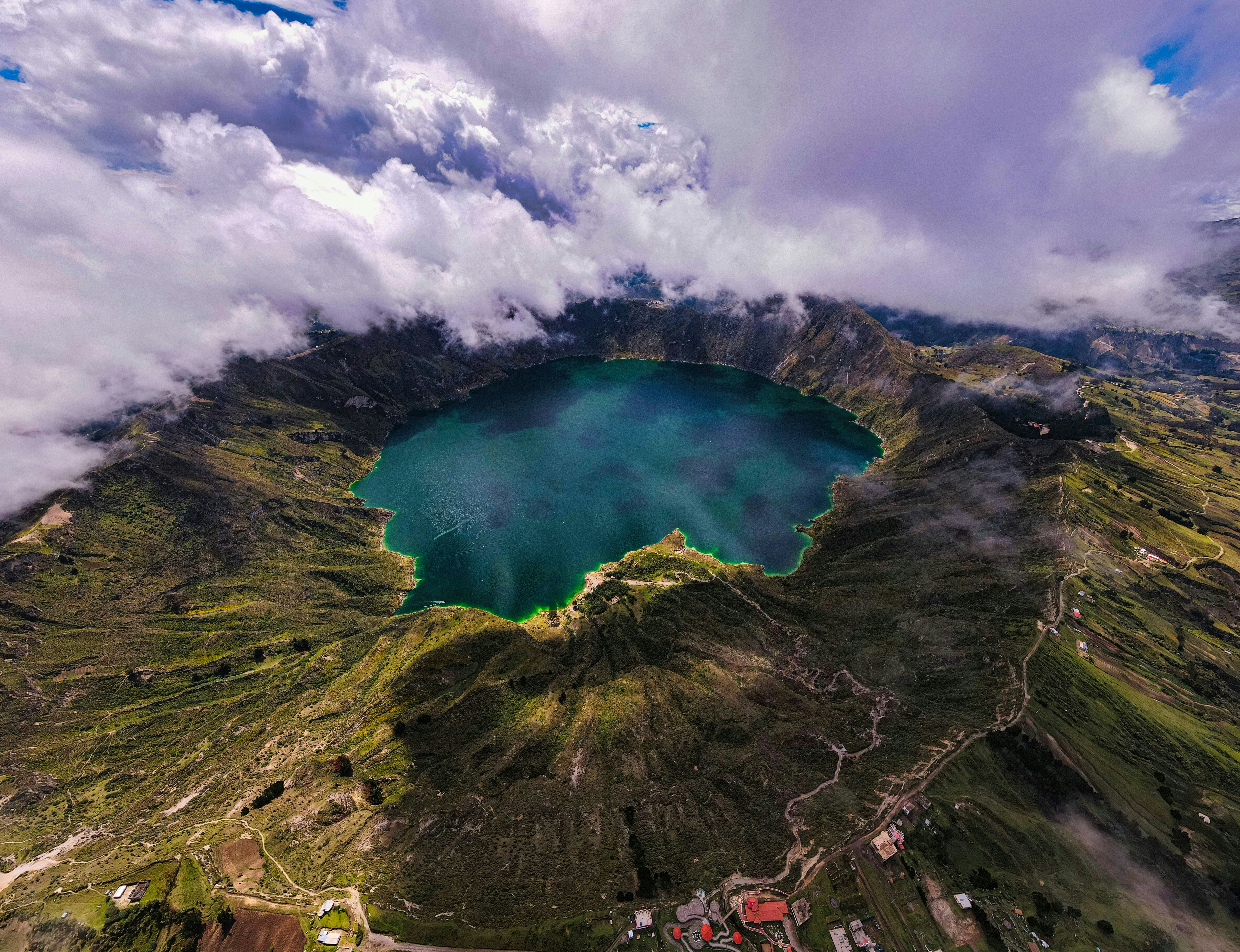 an aerial view of a lake surrounded by mountains, 