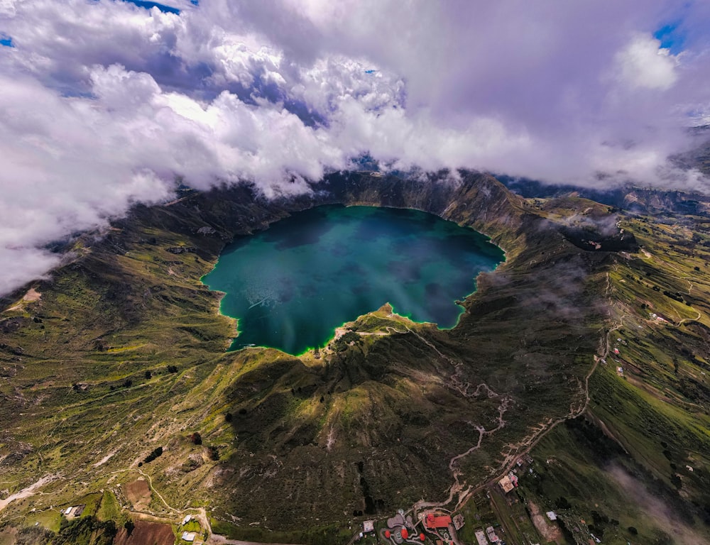 an aerial view of a lake surrounded by mountains