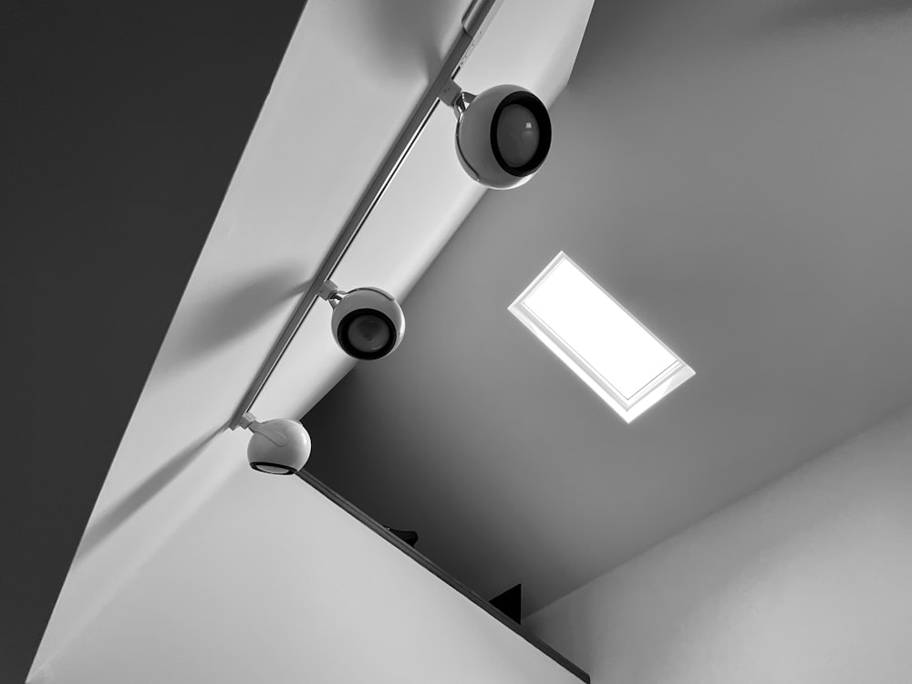 a bathroom with two lights and a skylight