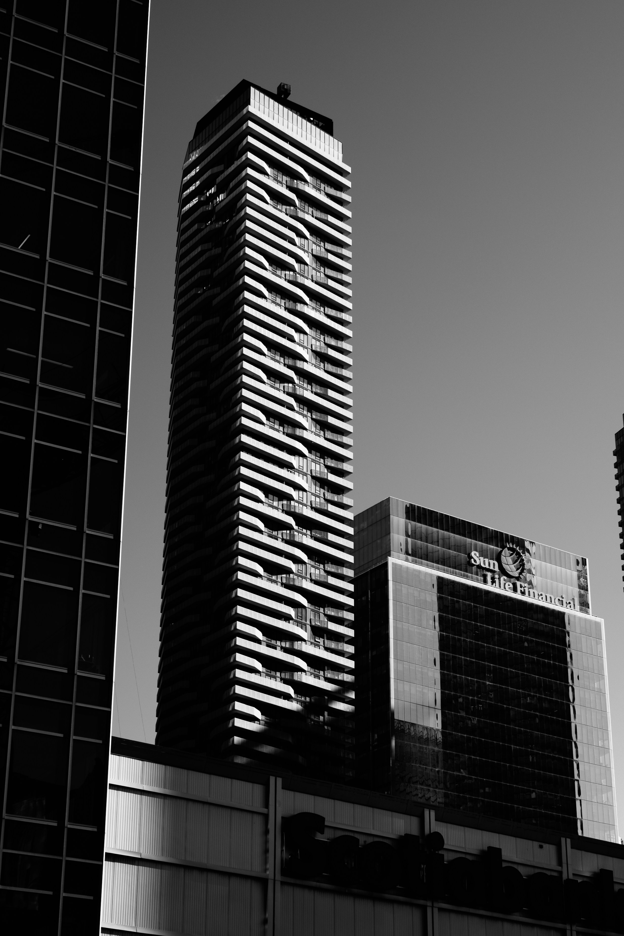 a black and white photo of two tall buildings