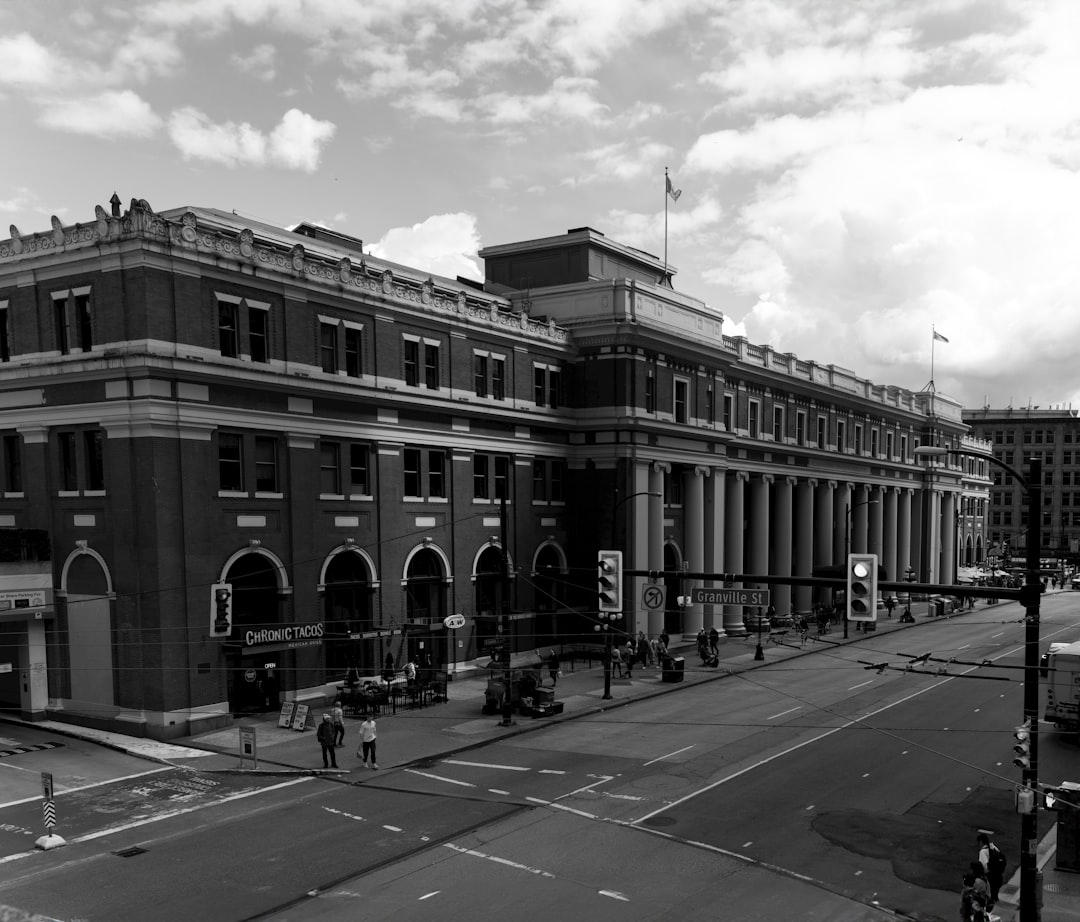 a black and white photo of a city street, Waterfront Station in Vancouver
