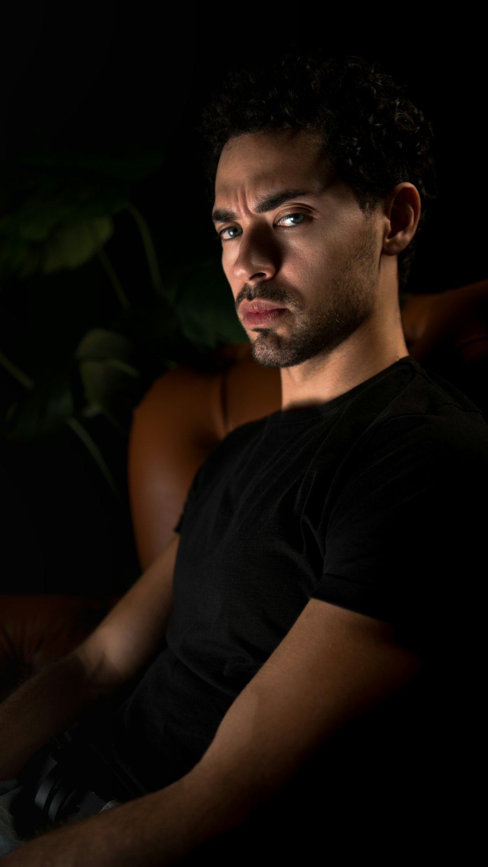 a man sitting in a chair with a laptop