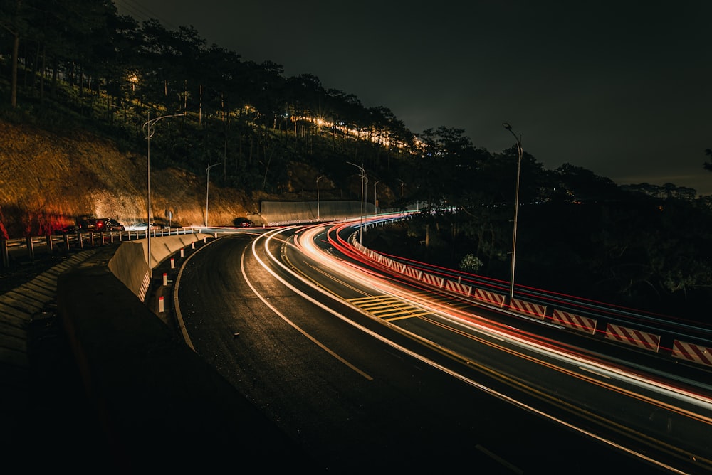 a long exposure photo of a highway at night