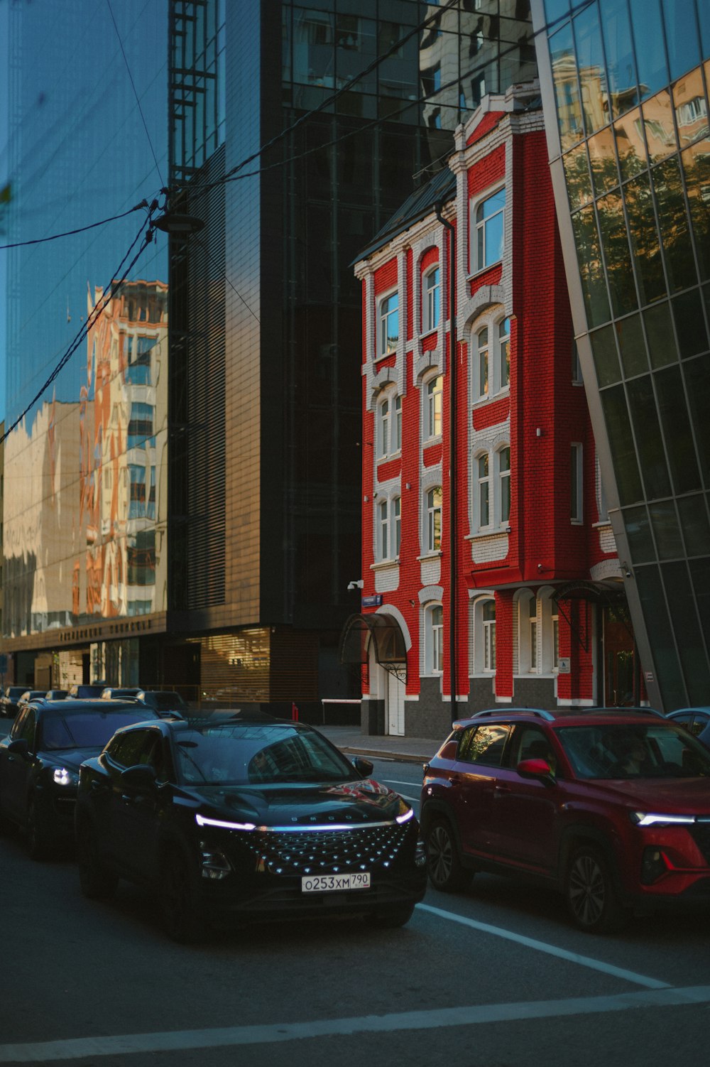 a city street filled with lots of traffic next to tall buildings