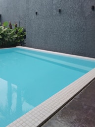 a large swimming pool with a tiled floor