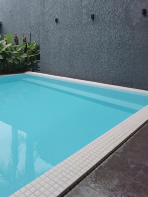 a large swimming pool with a tiled floor Pool Detail Sagaponack, NY