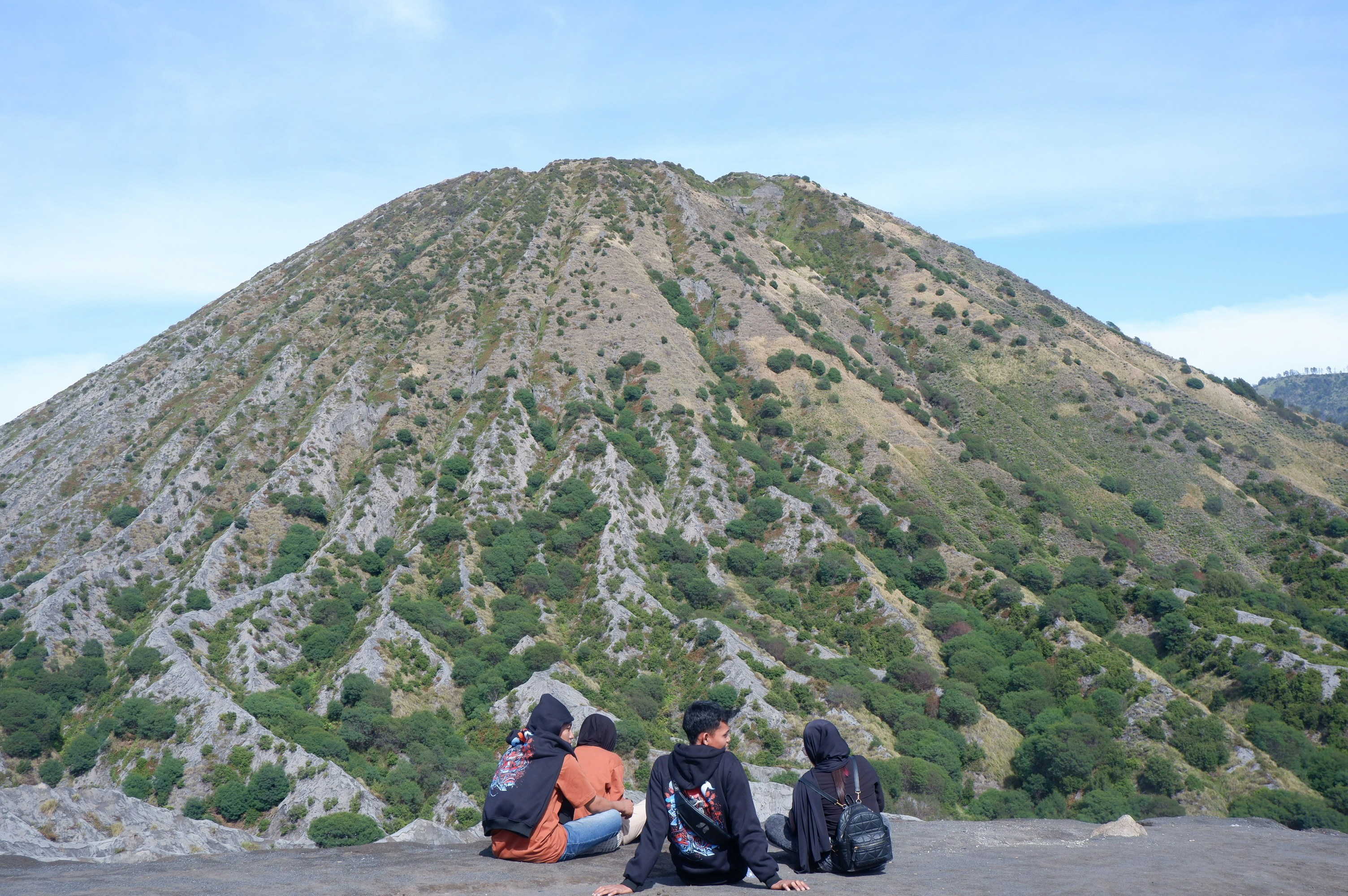 a group of people sitting on top of a mountain