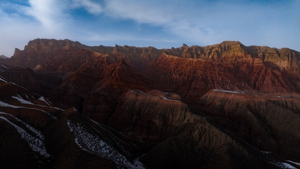 a view of a mountain range with snow on the ground