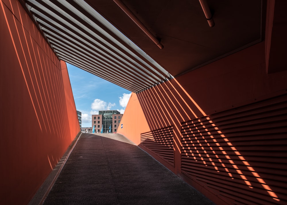 a walkway between two buildings with a sky background