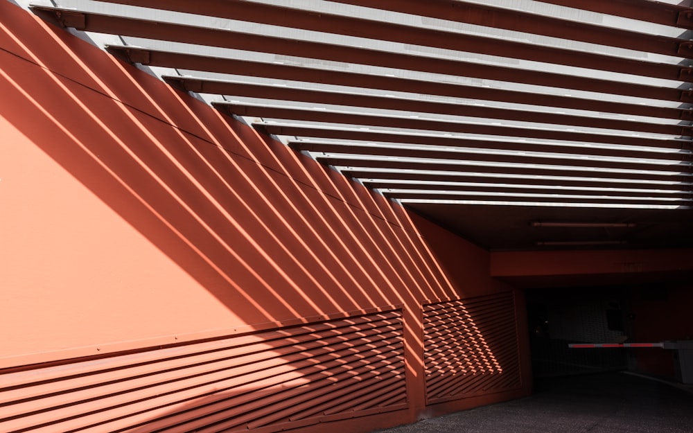 a red building with a metal slatted roof