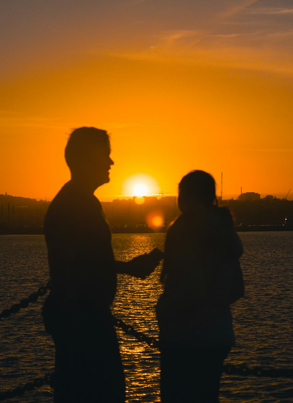 a couple of people that are standing in the water