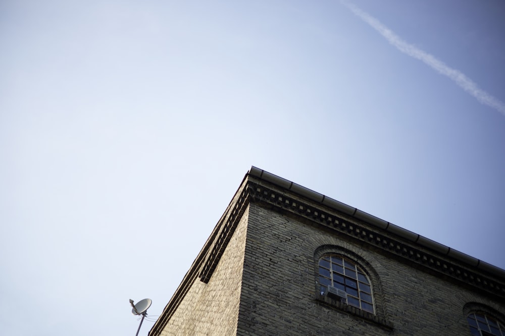 a tall brick building with a sky background