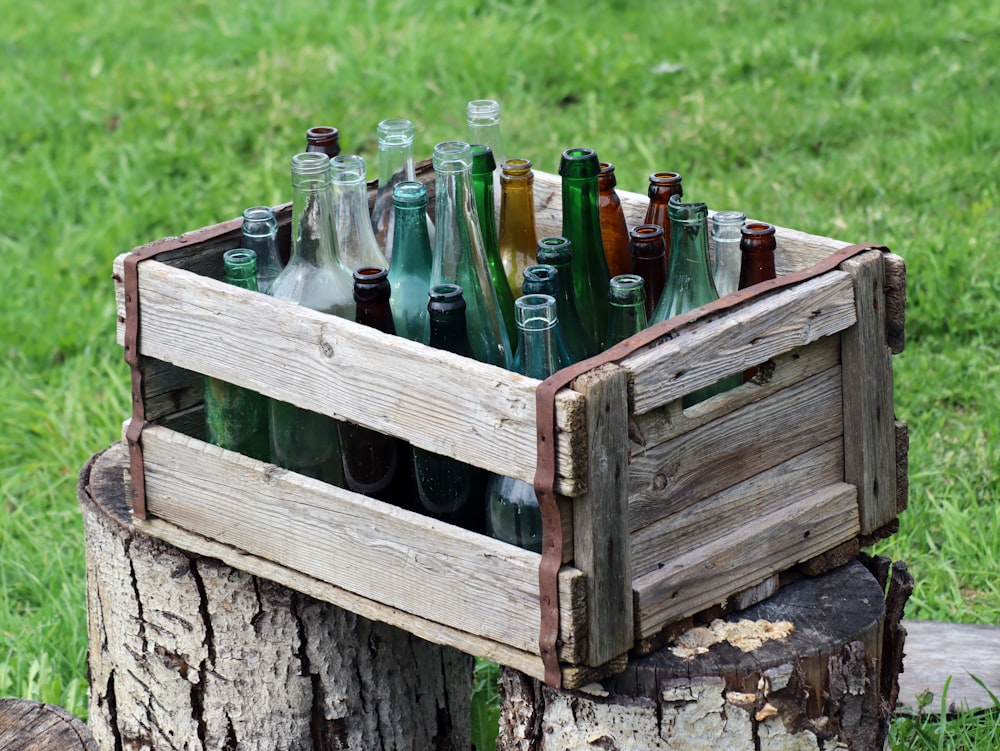a wooden crate filled with lots of empty bottles