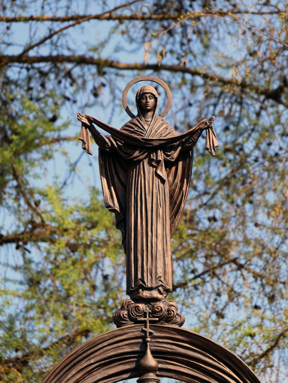 a statue of a woman on top of a pole