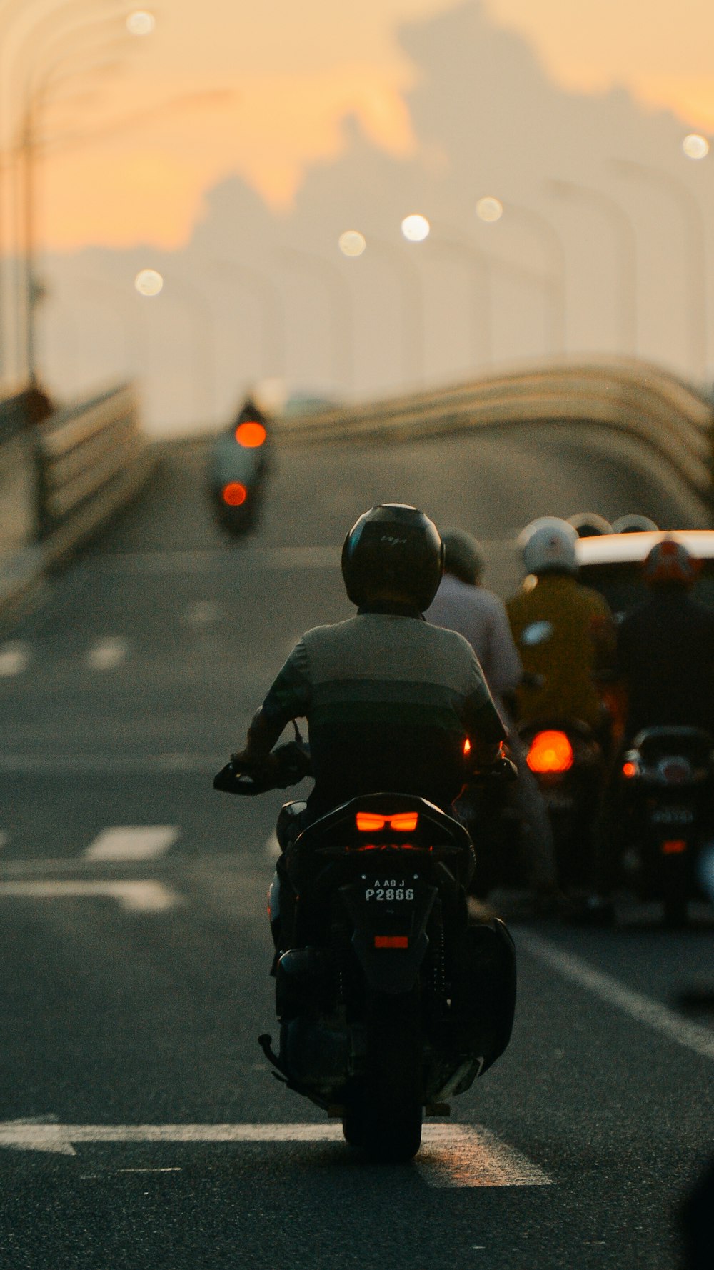 a group of people riding motorcycles down a highway