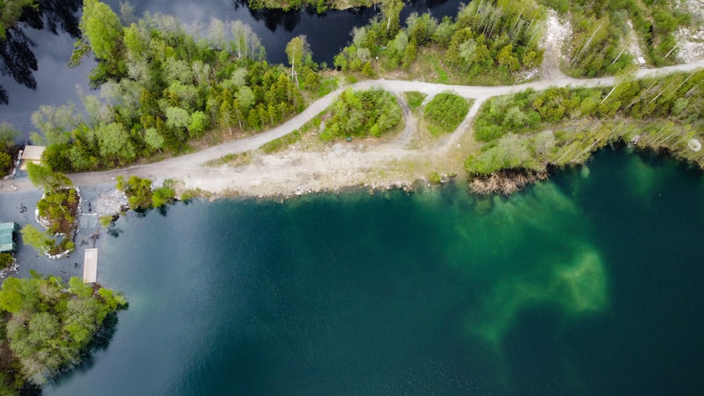 an aerial view of a lake surrounded by trees