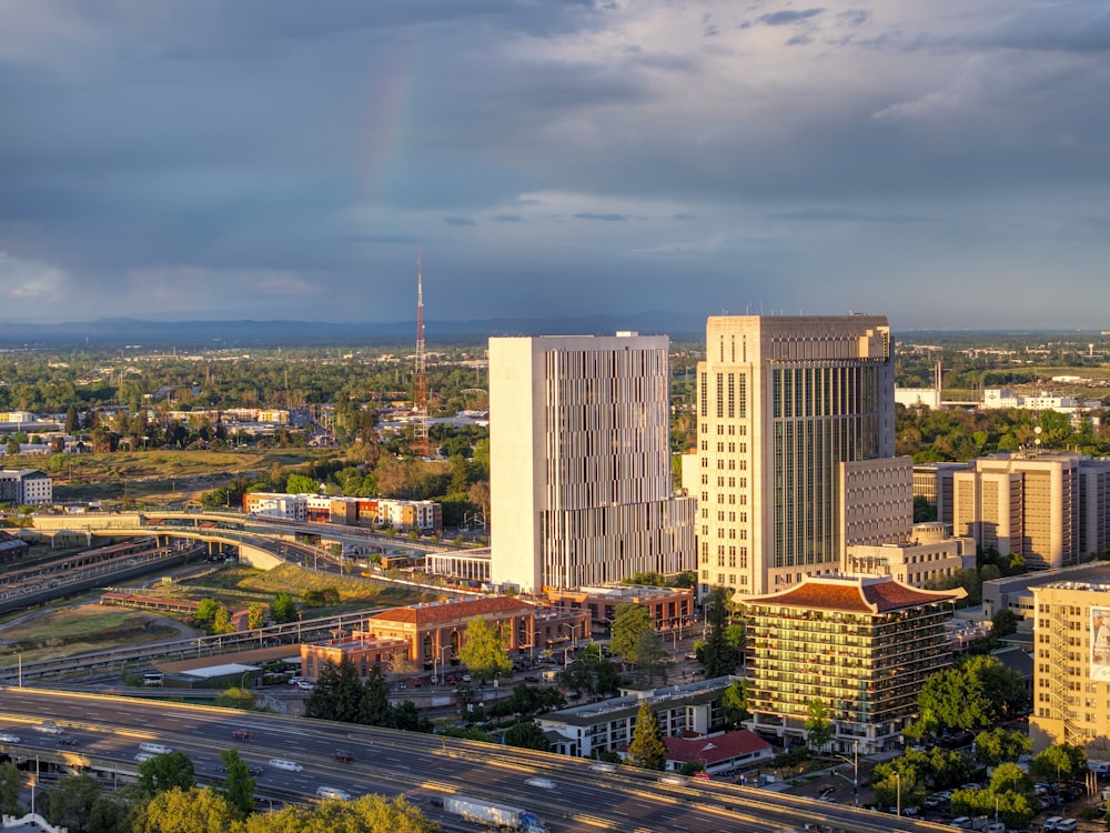 a view of a city with a rainbow in the sky