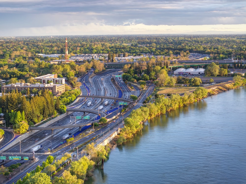 an aerial view of a highway near a river