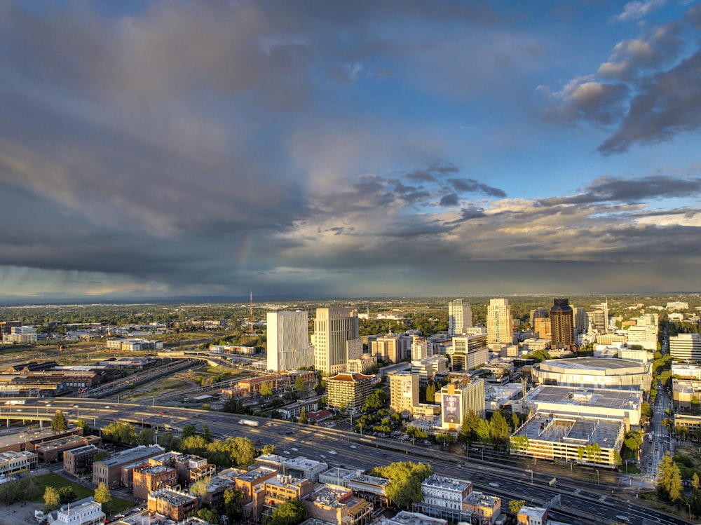 a view of a city with a rainbow in the sky