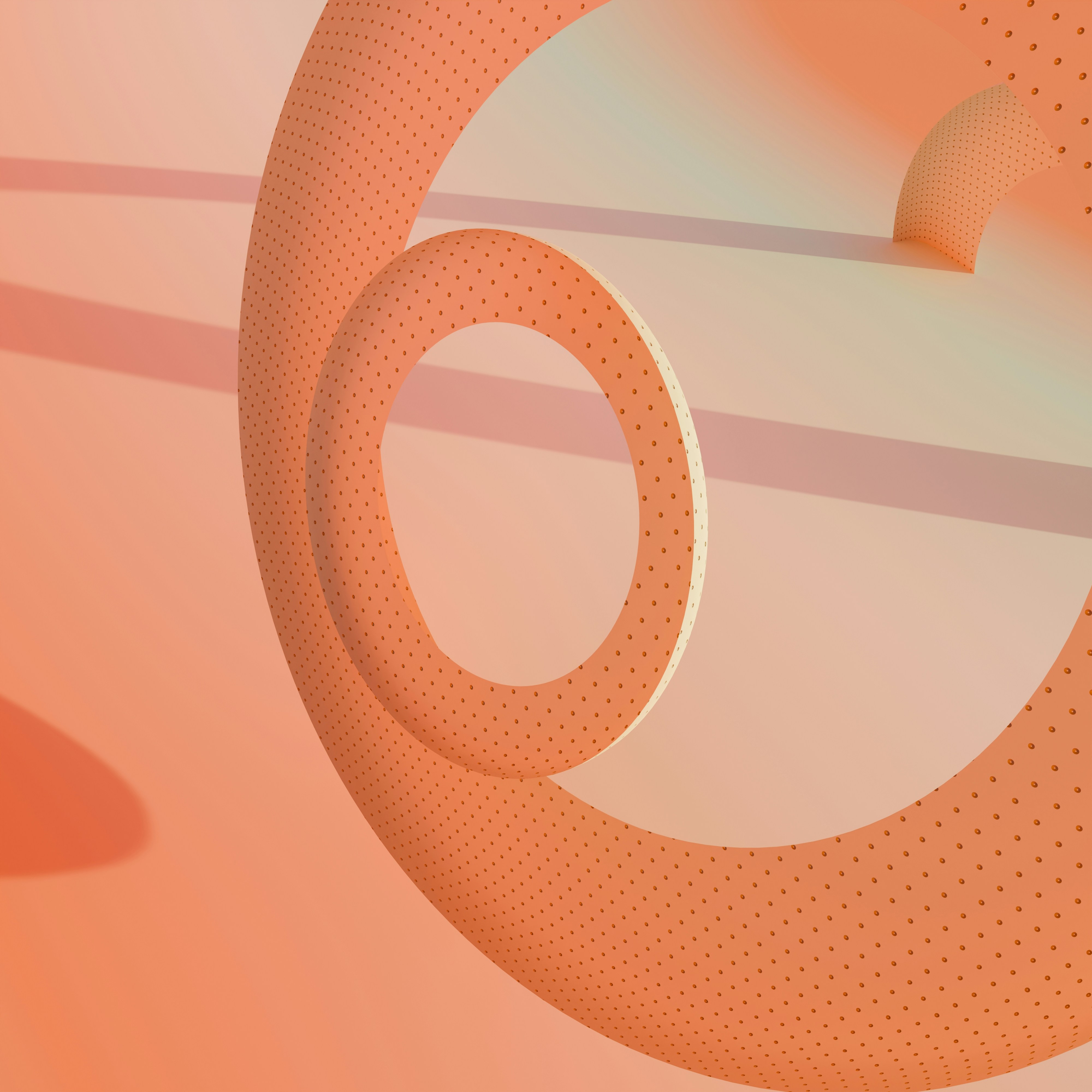 Un primer plano de un objeto circular sobre un fondo rosa
