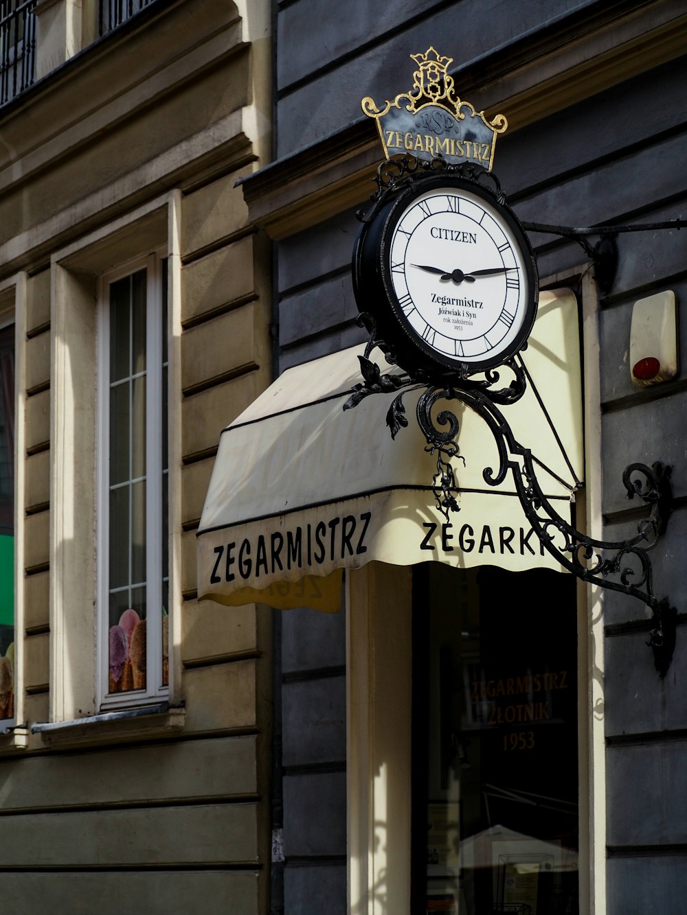 a black and white clock on the side of a building