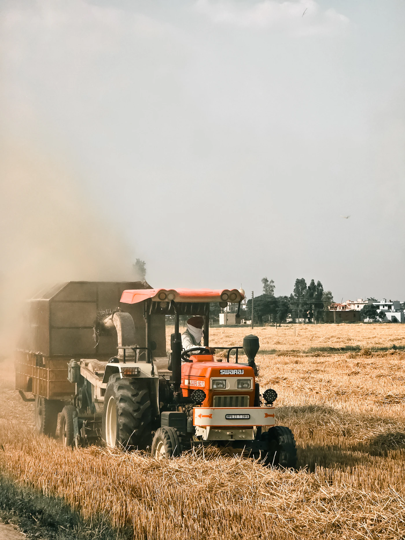 A tractor drives through a wheat field in Punjab.