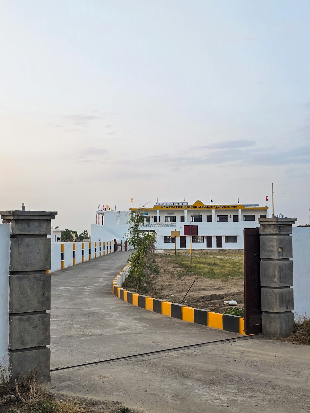 a large white building sitting next to a road